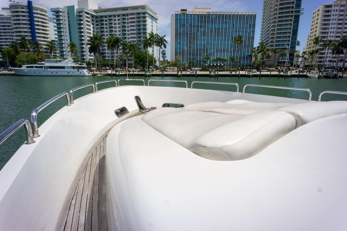 a white boat in a body of water with buildings in the background aboard OLD SPORT II Yacht for Sale