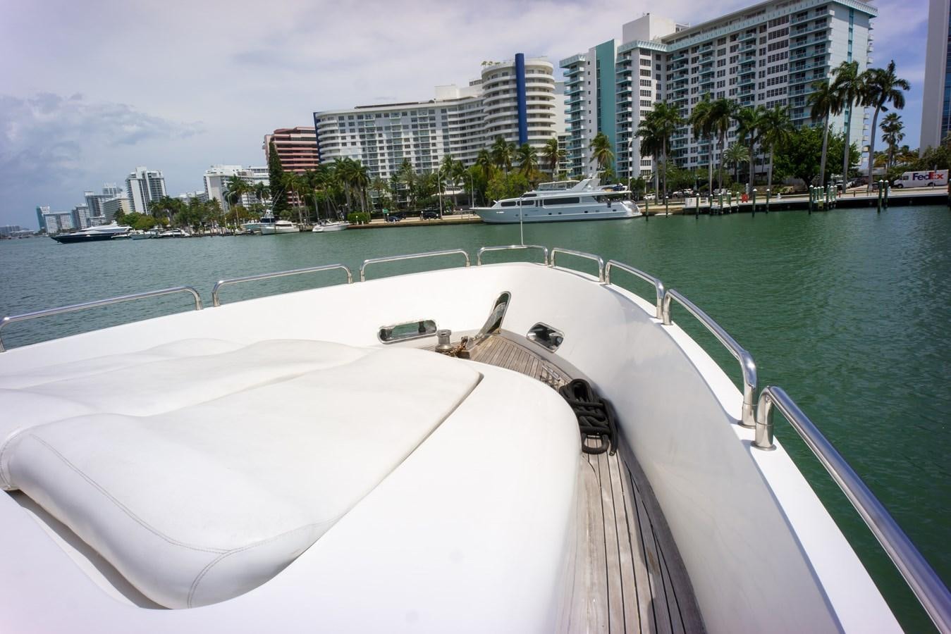 a large white boat on a body of water with buildings in the background aboard OLD SPORT II Yacht for Sale