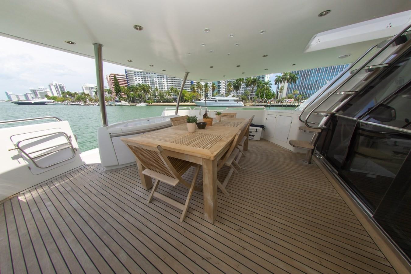 a deck with a table and chairs aboard OLD SPORT II Yacht for Sale