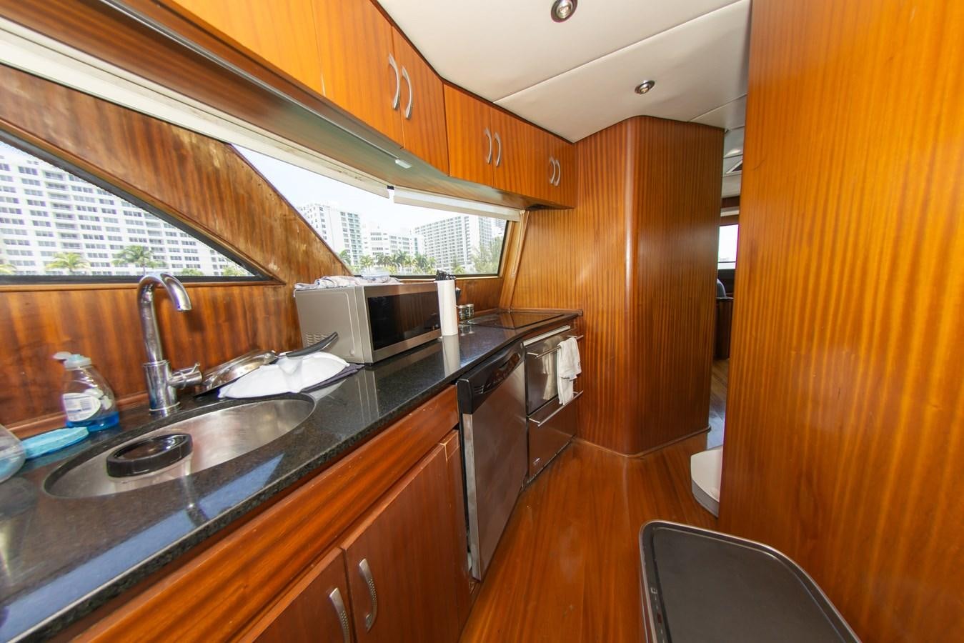 a kitchen with wooden cabinets aboard OLD SPORT II Yacht for Sale