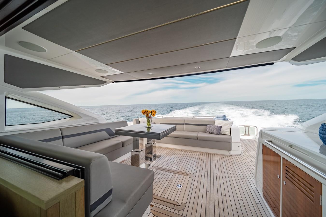 a boat with a table and chairs aboard BELLOW DECK Yacht for Sale