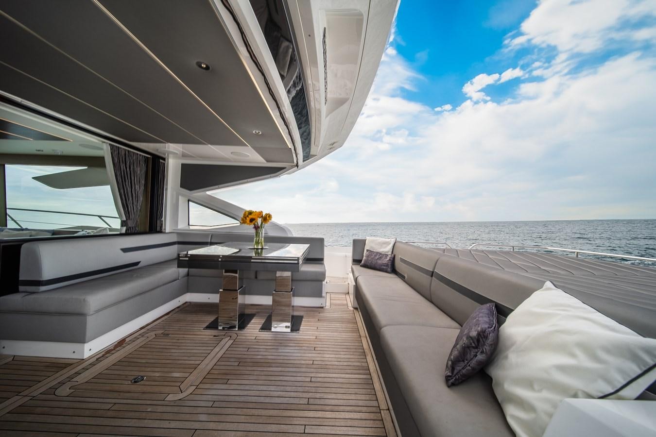 a room with a couch and a table and a window aboard BELLOW DECK Yacht for Sale