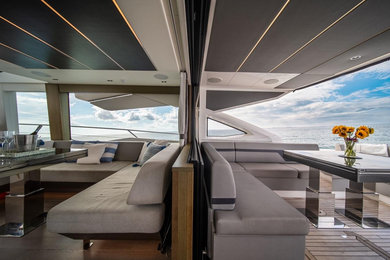 a room with a bed and a table with a vase of flowers aboard BELLOW DECK Yacht for Sale