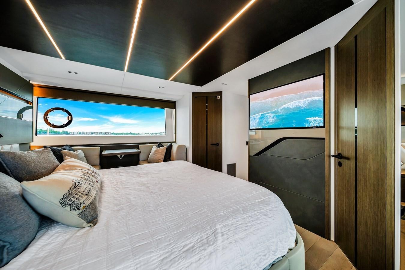 a bed with a television on the wall aboard BELLOW DECK Yacht for Sale