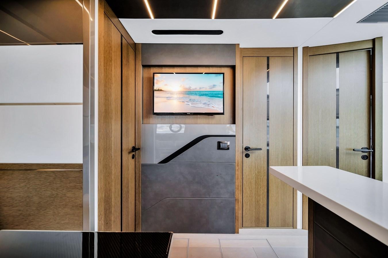 a room with a large mirror and a counter with a sink and a television on it aboard BELLOW DECK Yacht for Sale