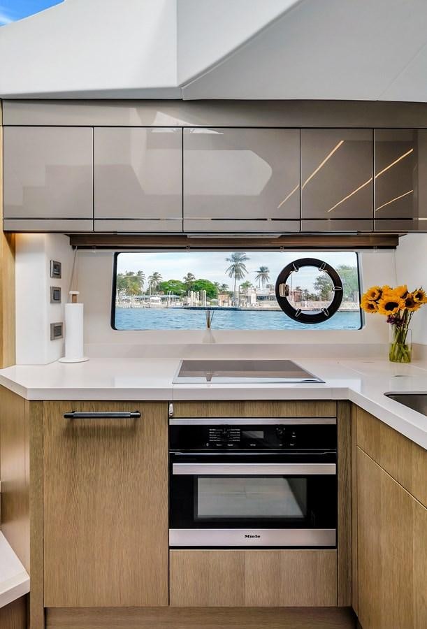 a kitchen with a large window aboard BELLOW DECK Yacht for Sale