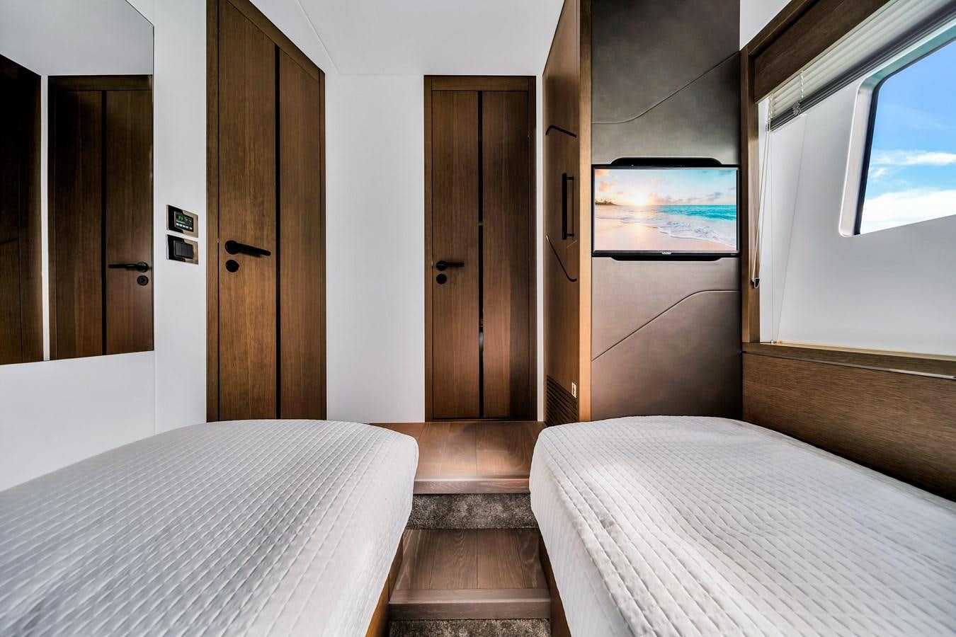 a room with a bed and a mirror aboard BELLOW DECK Yacht for Sale