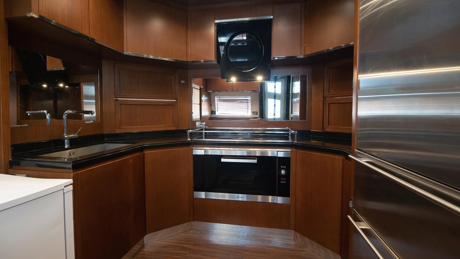 a kitchen with wooden cabinets aboard KOUKLES Yacht for Sale