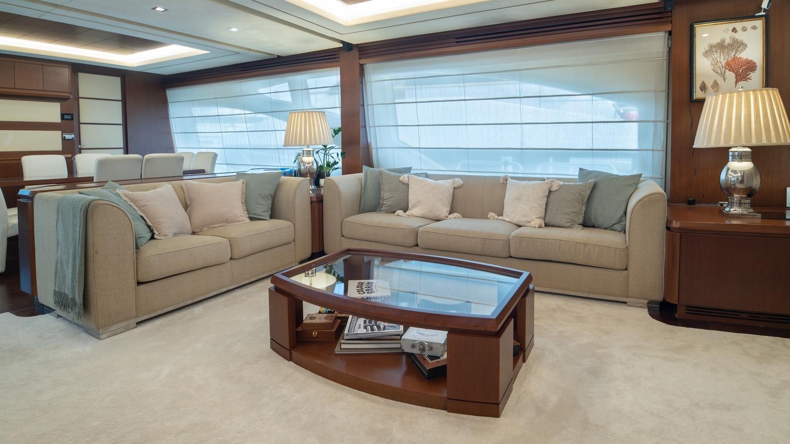 a living room with a couch and a coffee table aboard KOUKLES Yacht for Sale