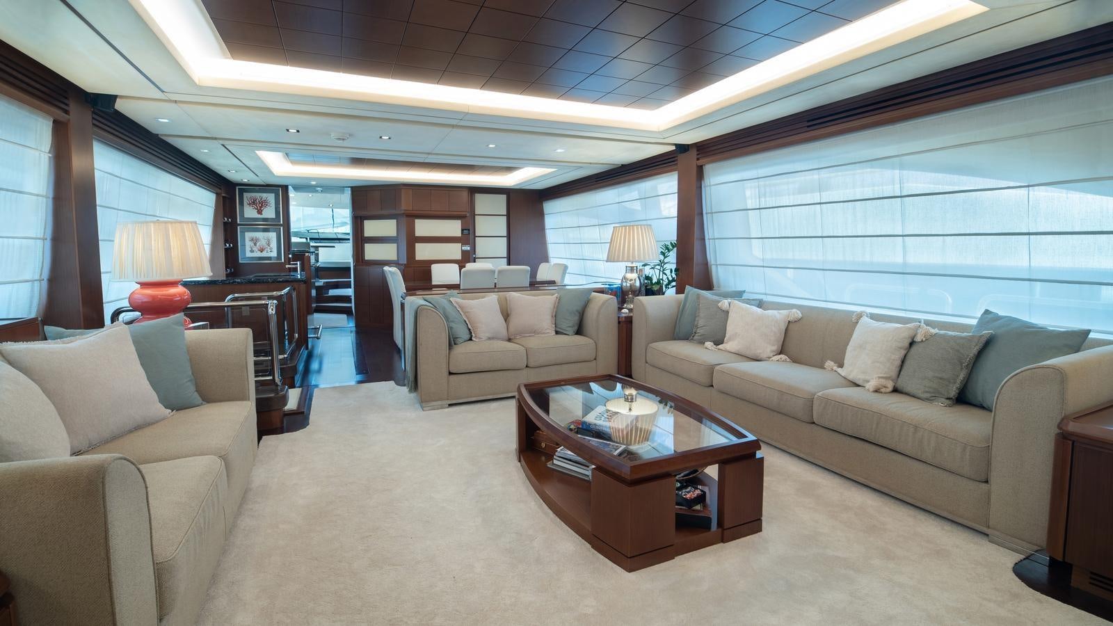 a living room with a couch and a coffee table aboard KOUKLES Yacht for Sale