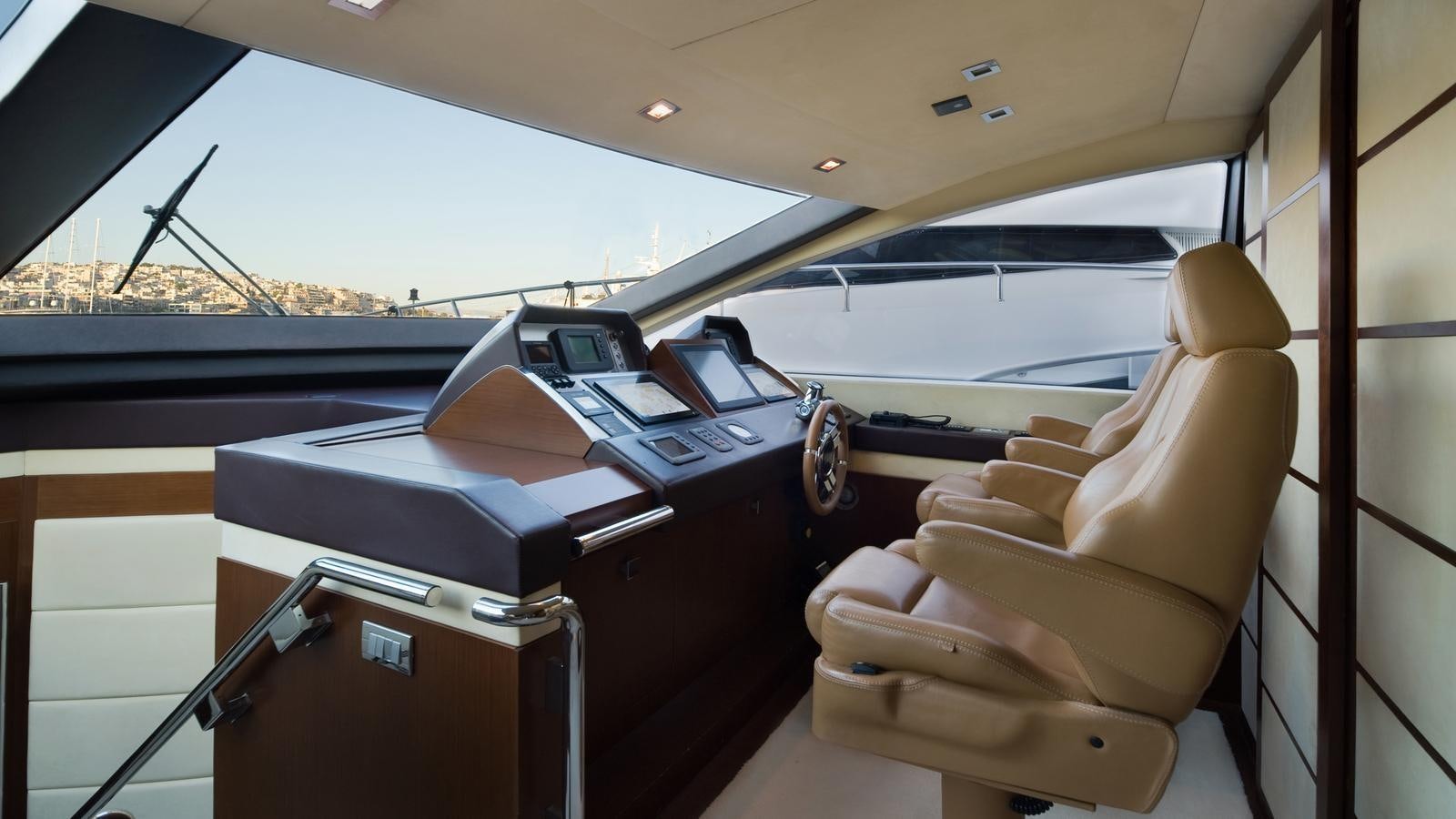 a boat with a seat and a desk with a chair aboard KOUKLES Yacht for Sale