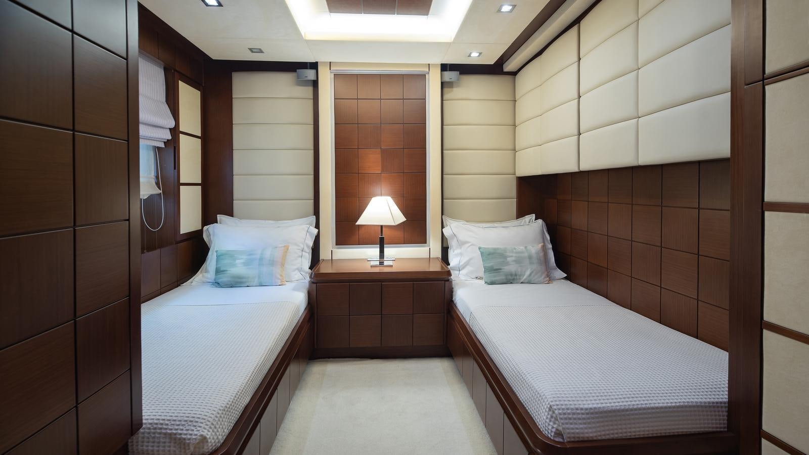 a couple of beds in a hotel room aboard KOUKLES Yacht for Sale