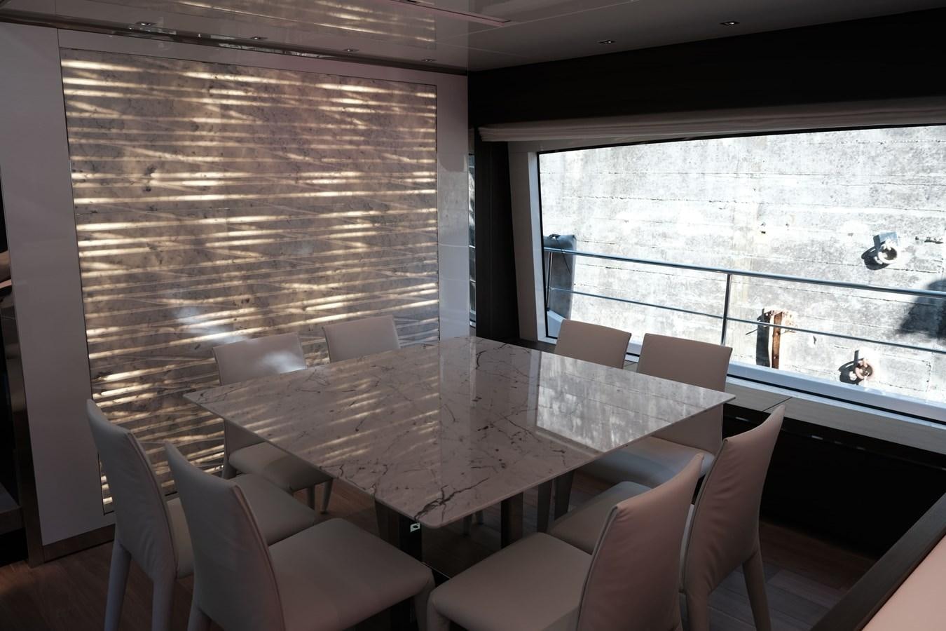 a room with a table chairs and a window aboard SL86 Yacht for Sale
