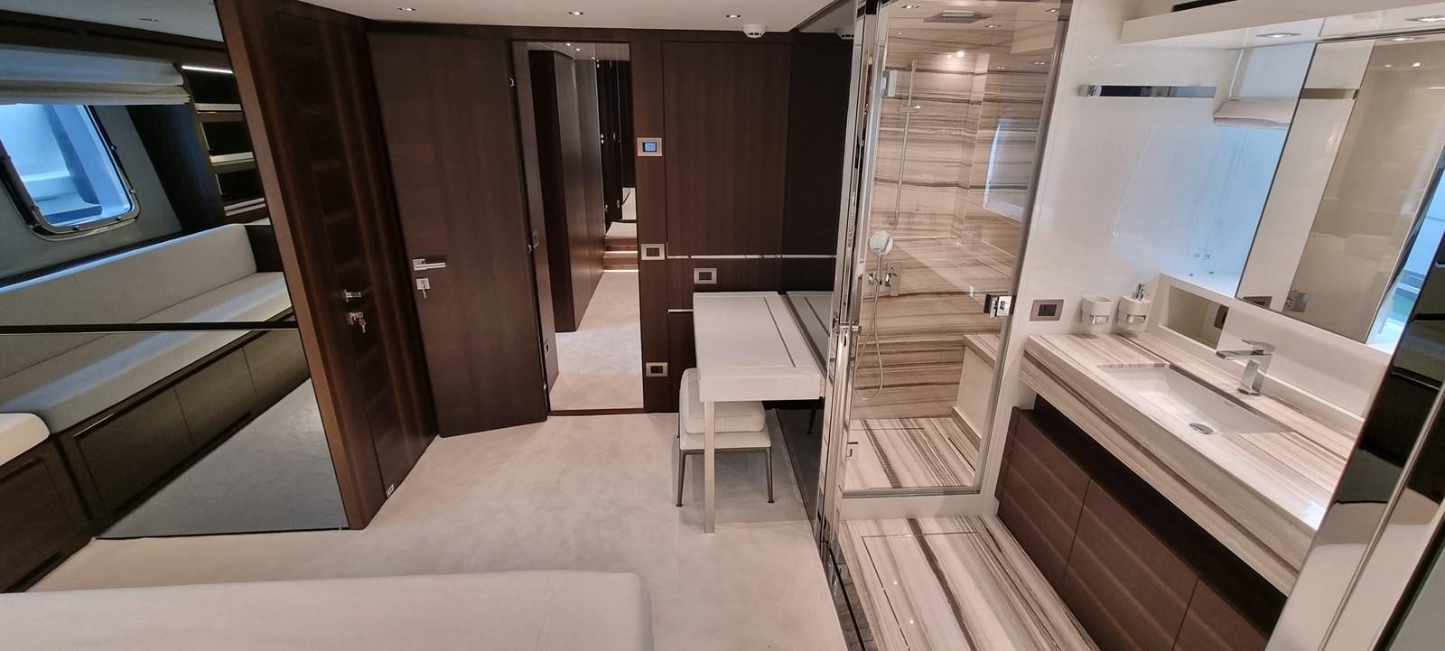 a room with a table and chairs aboard SL86 Yacht for Sale