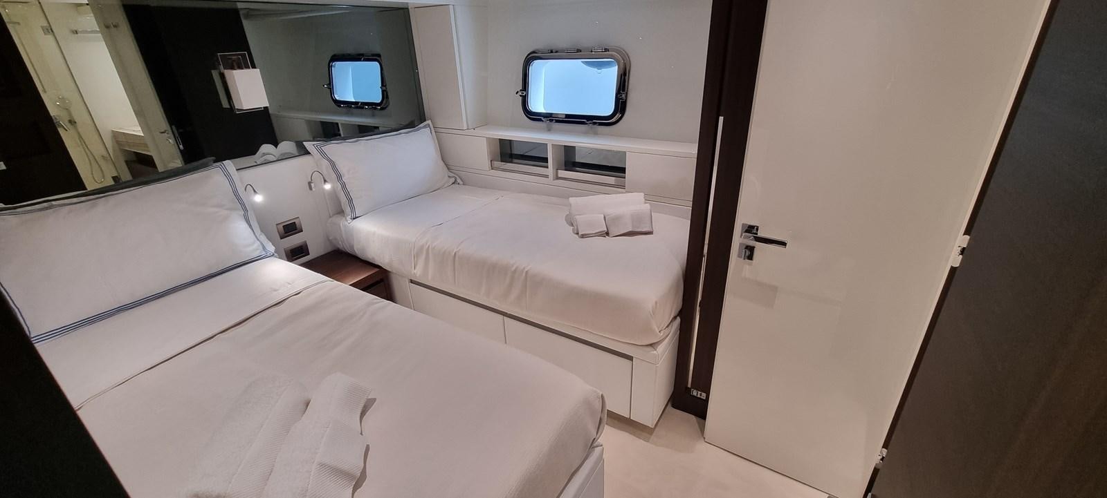 a room with a bed and a tv on the wall aboard SL86 Yacht for Sale