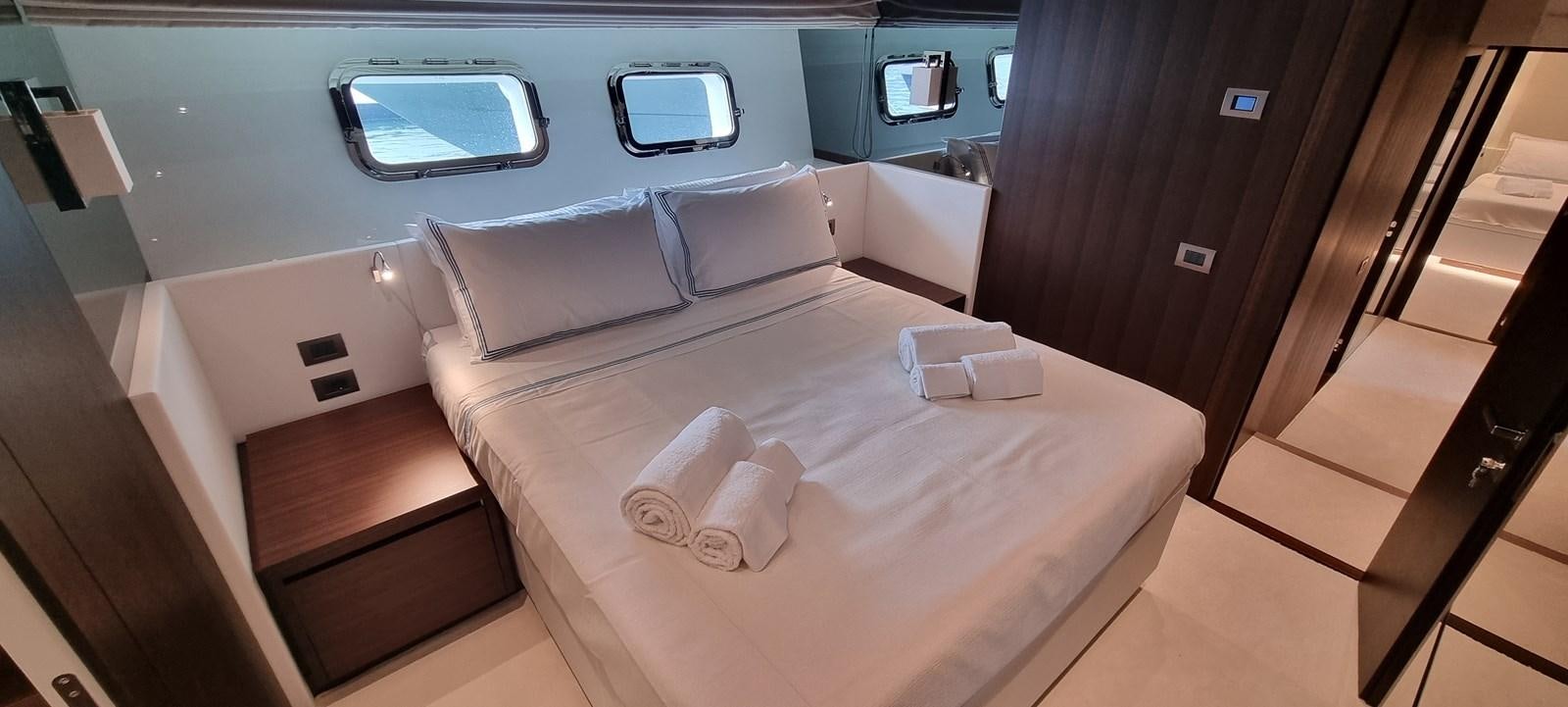 a room with a bed and a window aboard SL86 Yacht for Sale