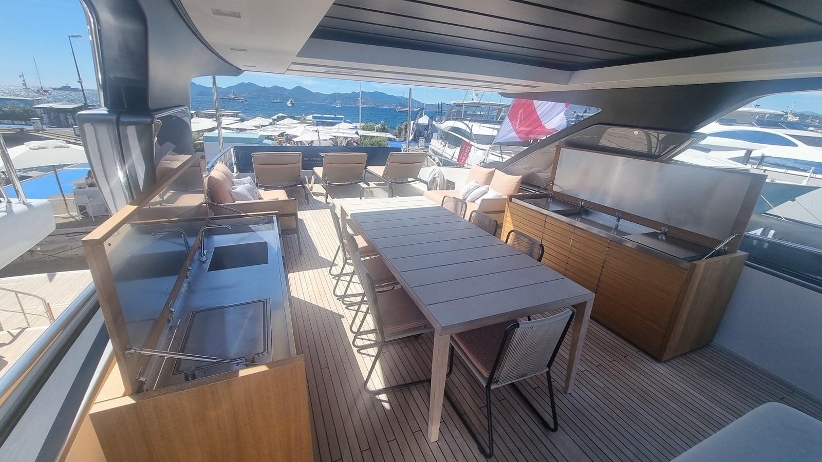 a deck with a table and chairs aboard SL86 Yacht for Sale