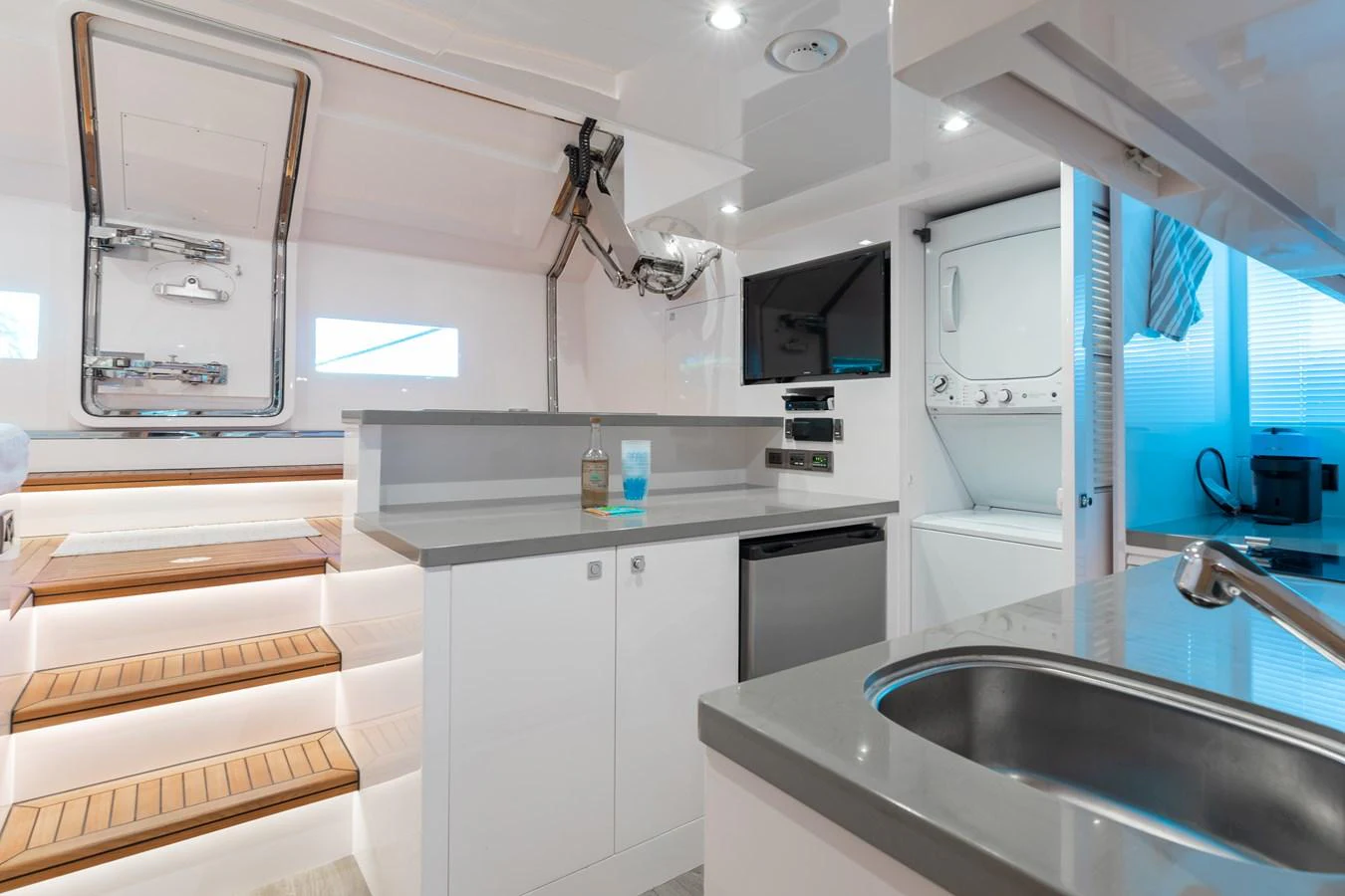 a kitchen with white cabinets aboard ONE MORE TIME Yacht for Sale