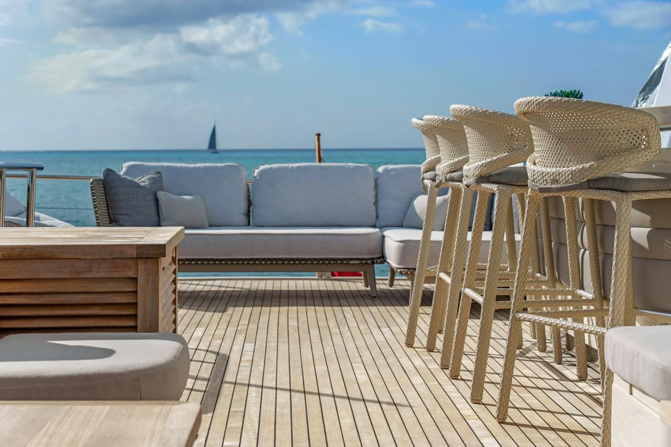 a deck with chairs and a table on it aboard CURRENT $EA Yacht for Sale
