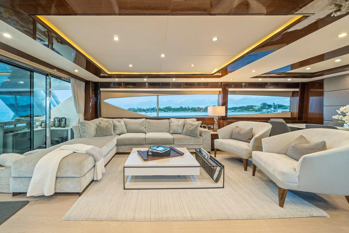 a living room with a large window aboard CURRENT $EA Yacht for Sale