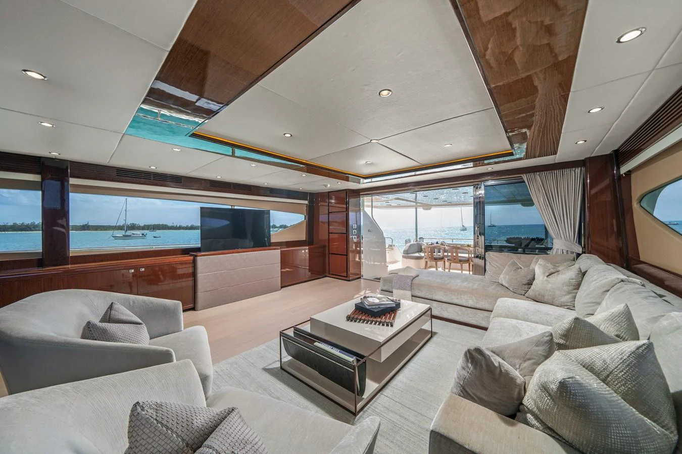 a living room with a large window aboard CURRENT $EA Yacht for Sale
