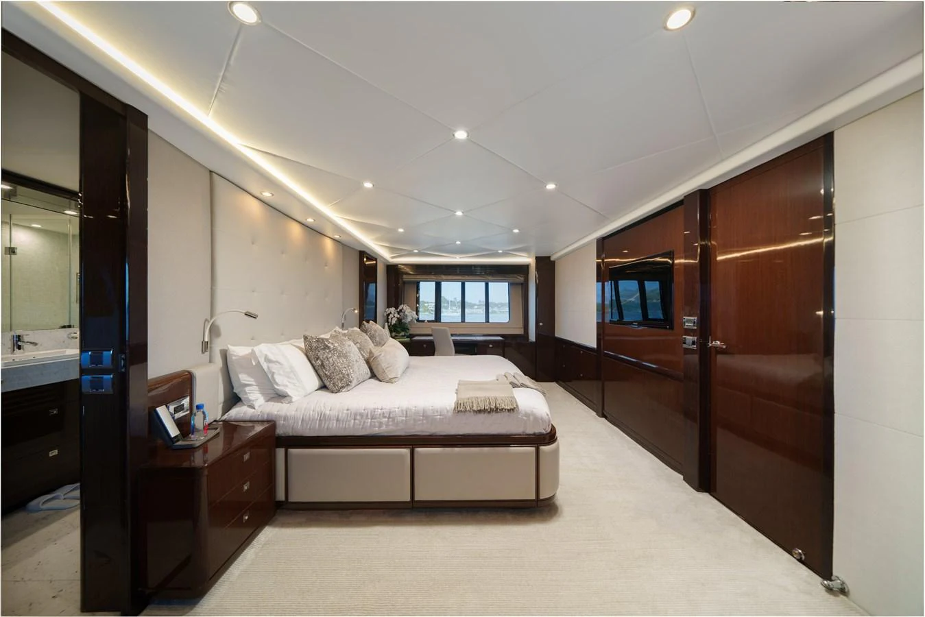 a bedroom with a bed and a desk aboard CURRENT $EA Yacht for Sale