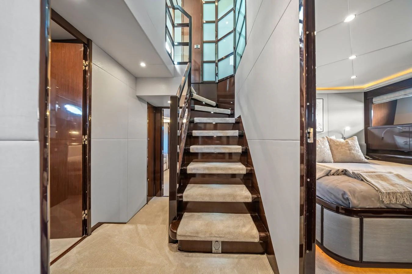 a room with a bed and a staircase aboard CURRENT $EA Yacht for Sale