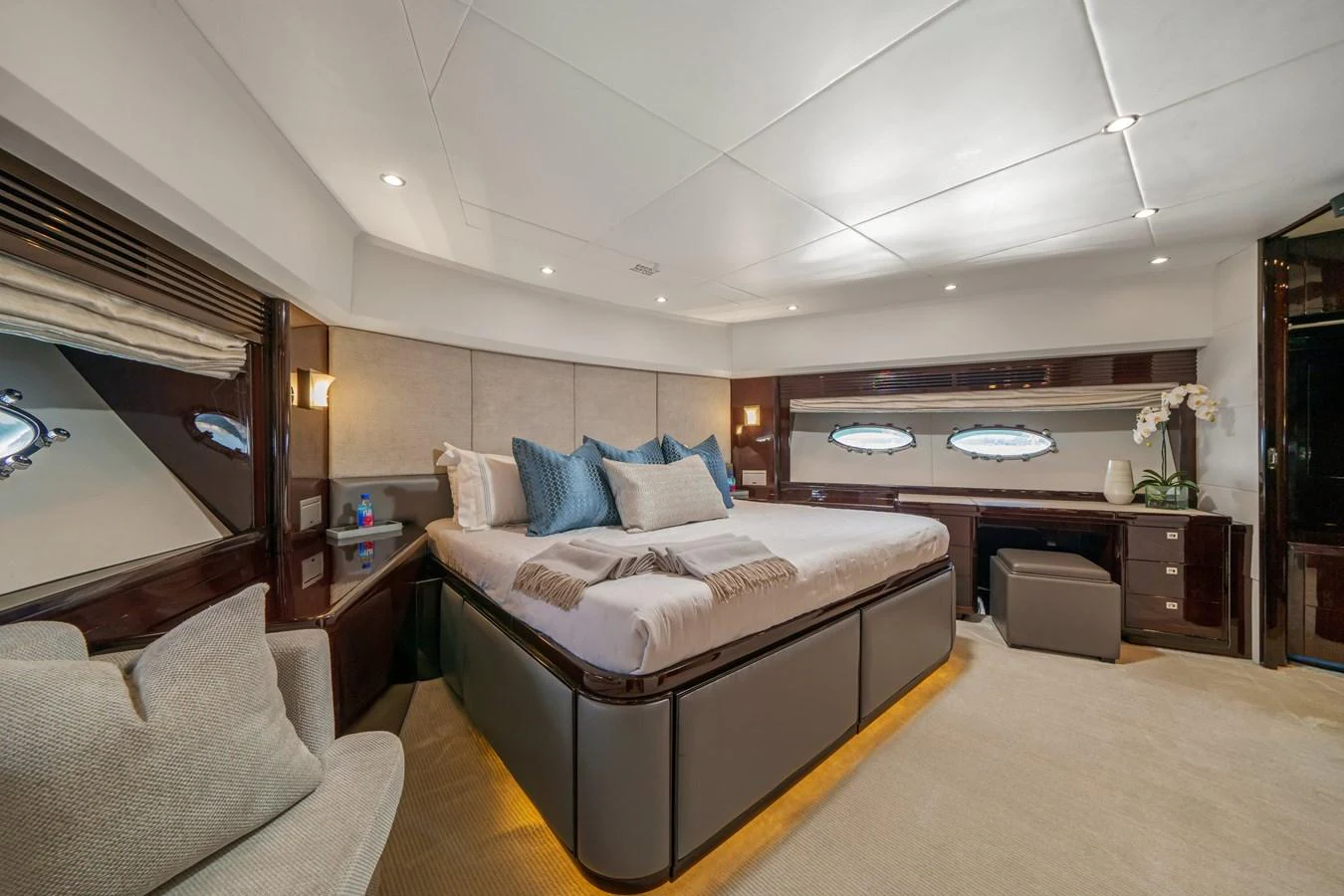 a bedroom with a bed and a couch aboard CURRENT $EA Yacht for Sale