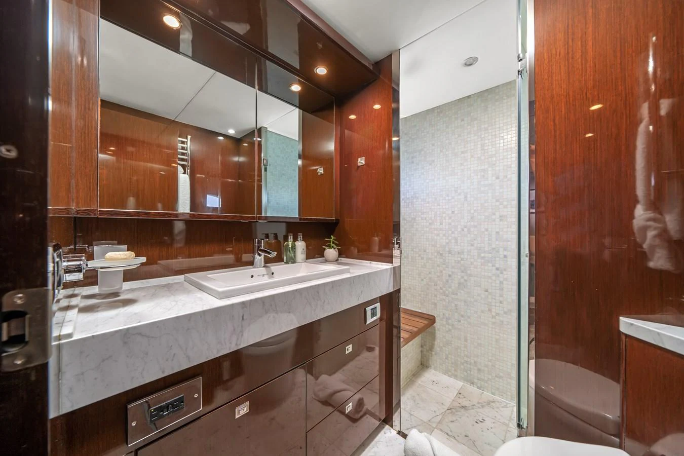 a bathroom with a large mirror aboard CURRENT $EA Yacht for Sale