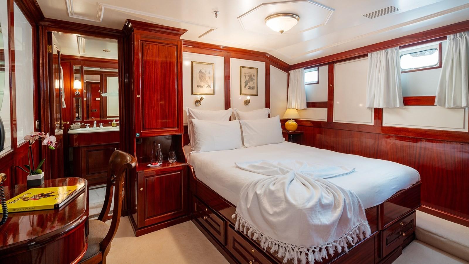 a room with a bed and a desk aboard SEA LION Yacht for Sale