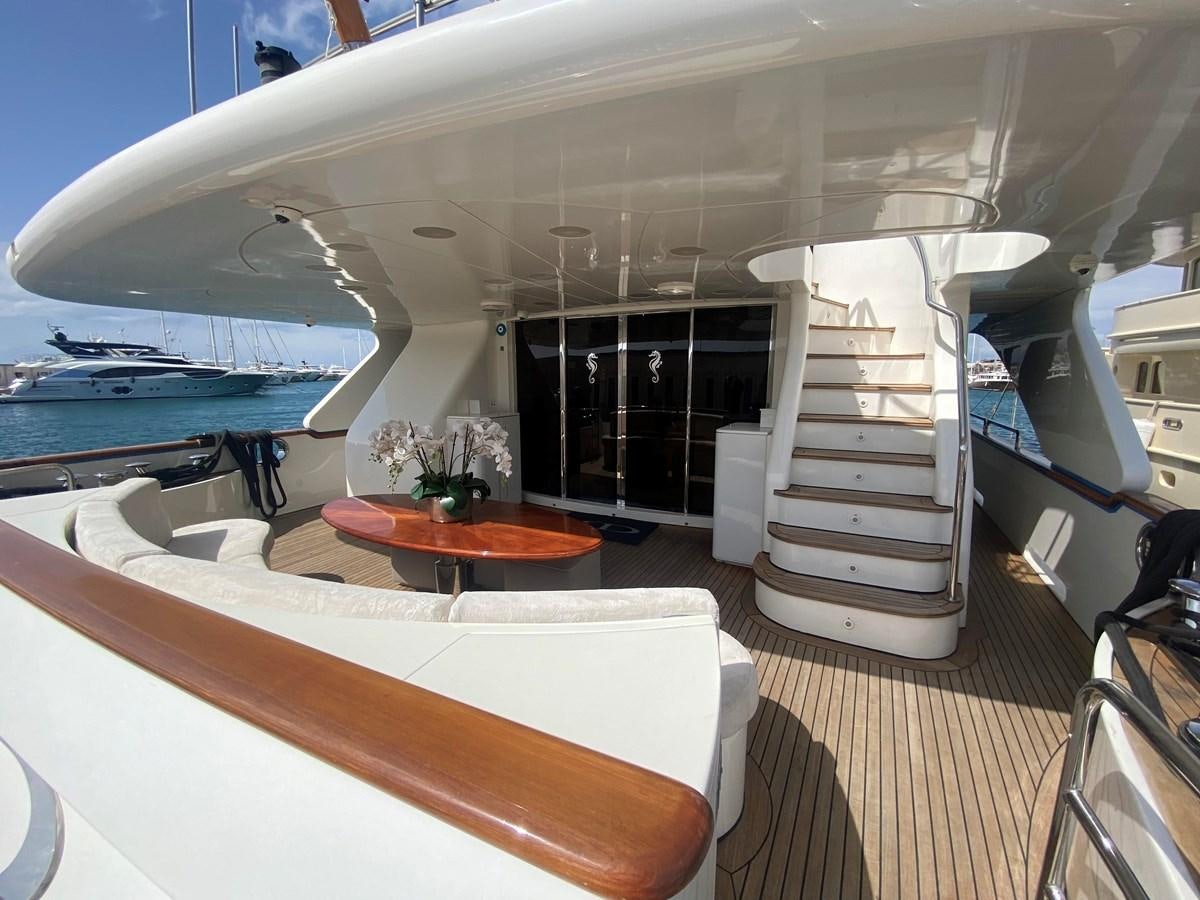 a room with a table and a bed aboard B-D Yacht for Sale