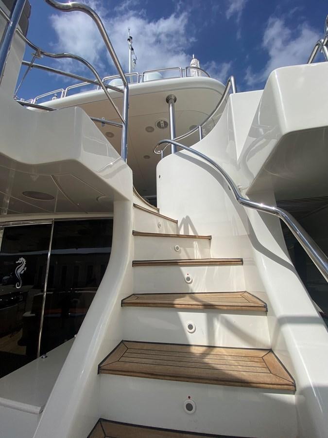 a white boat with a metal frame aboard B-D Yacht for Sale
