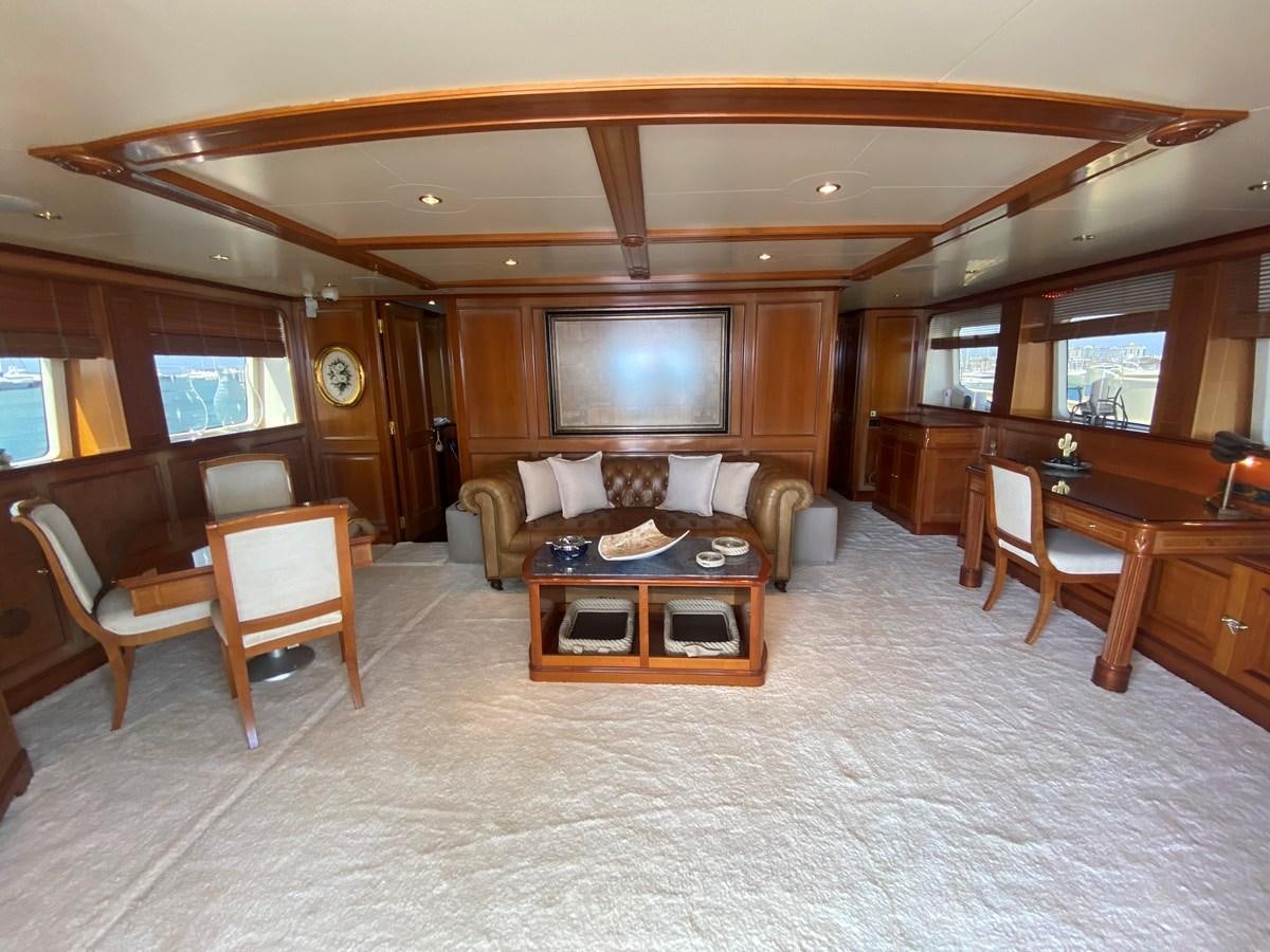 a living room with a large screen aboard B-D Yacht for Sale