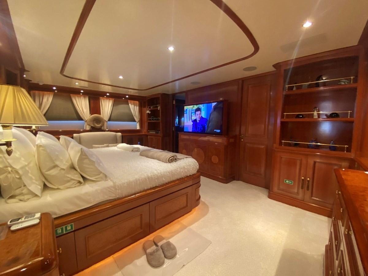 a bedroom with a bed and a television aboard B-D Yacht for Sale