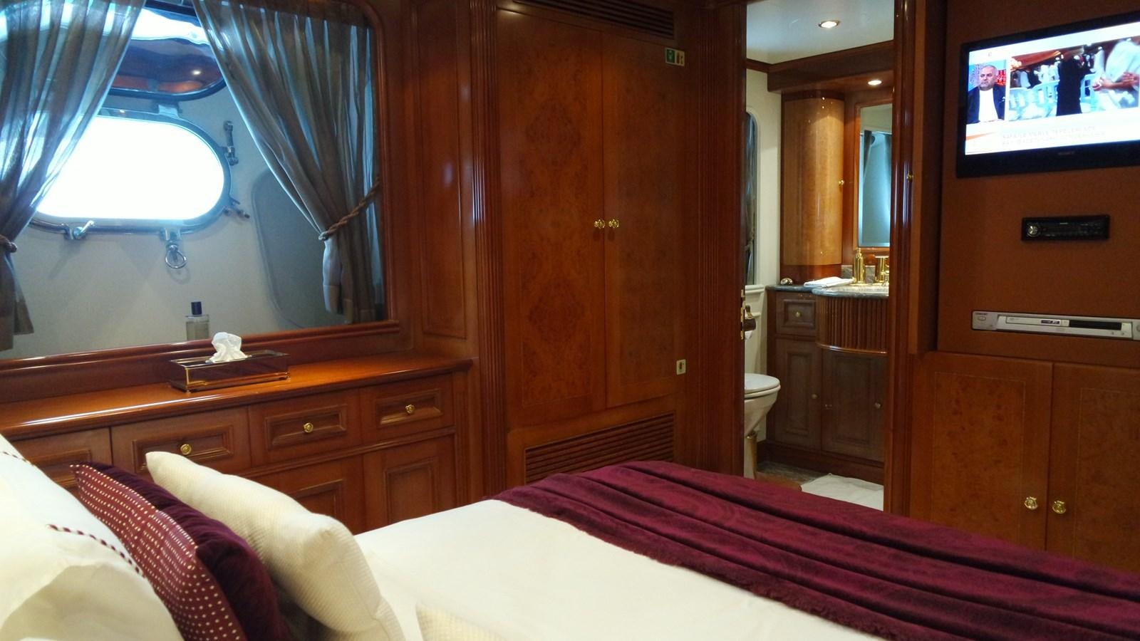 a room with a bed and a television aboard B-D Yacht for Sale
