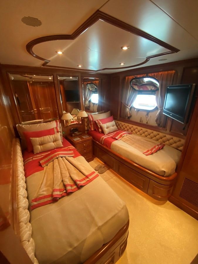 a room with a bed and a television aboard B-D Yacht for Sale
