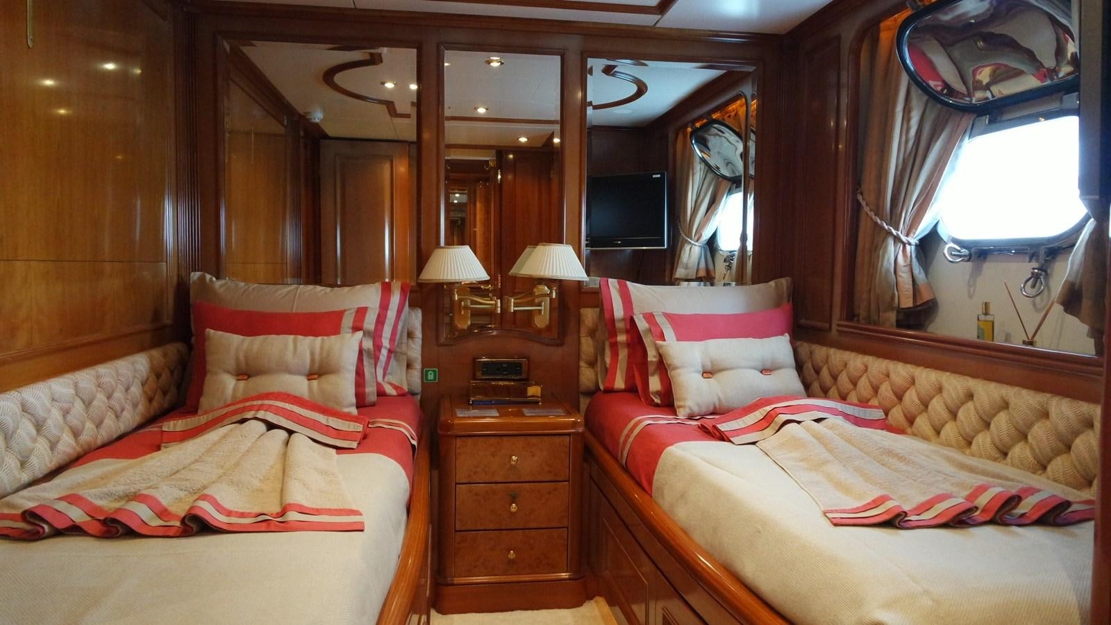 a room with a bed and a mirror aboard B-D Yacht for Sale