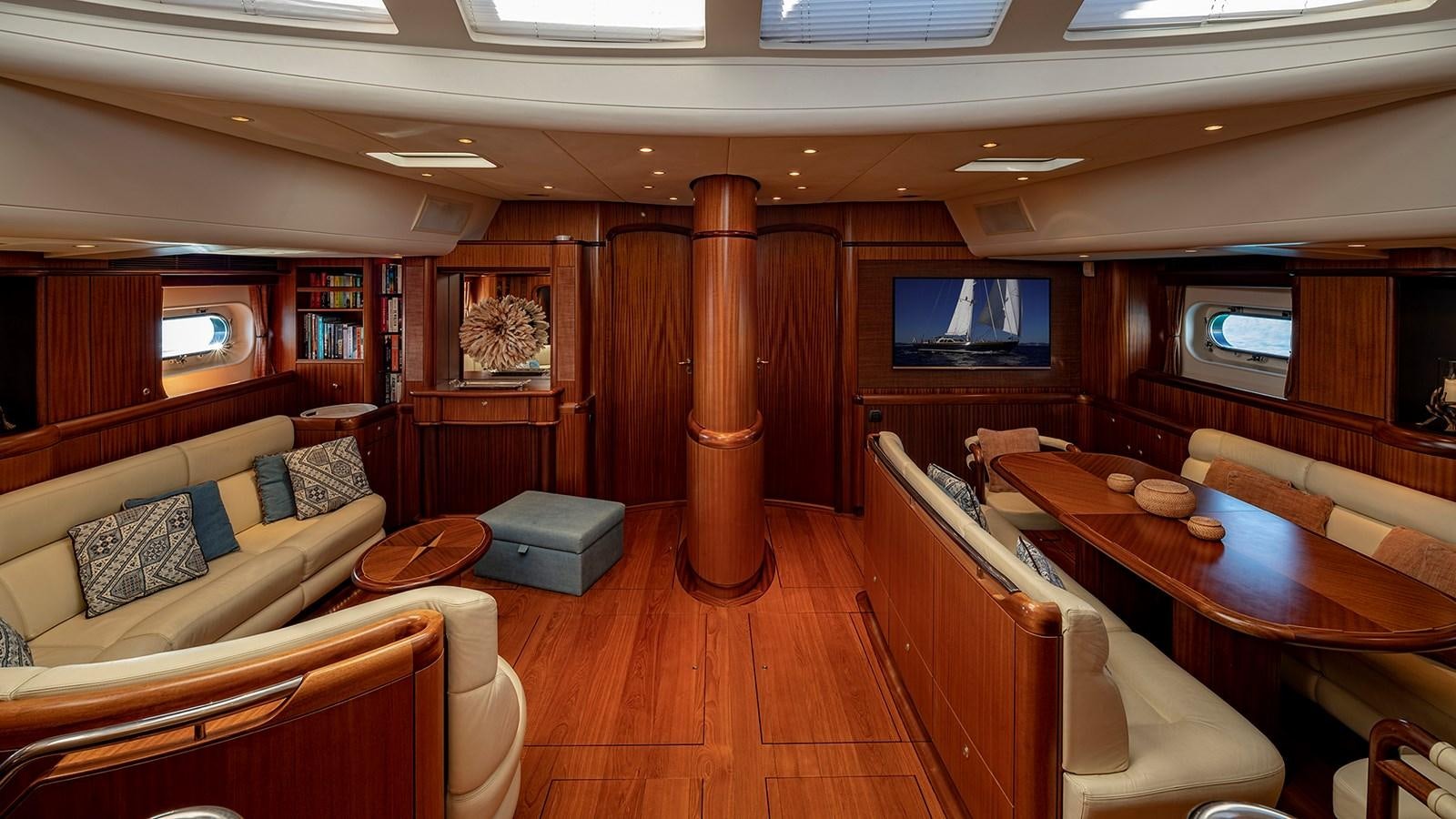 a room with a table and couches aboard GOOD TIMES Yacht for Sale