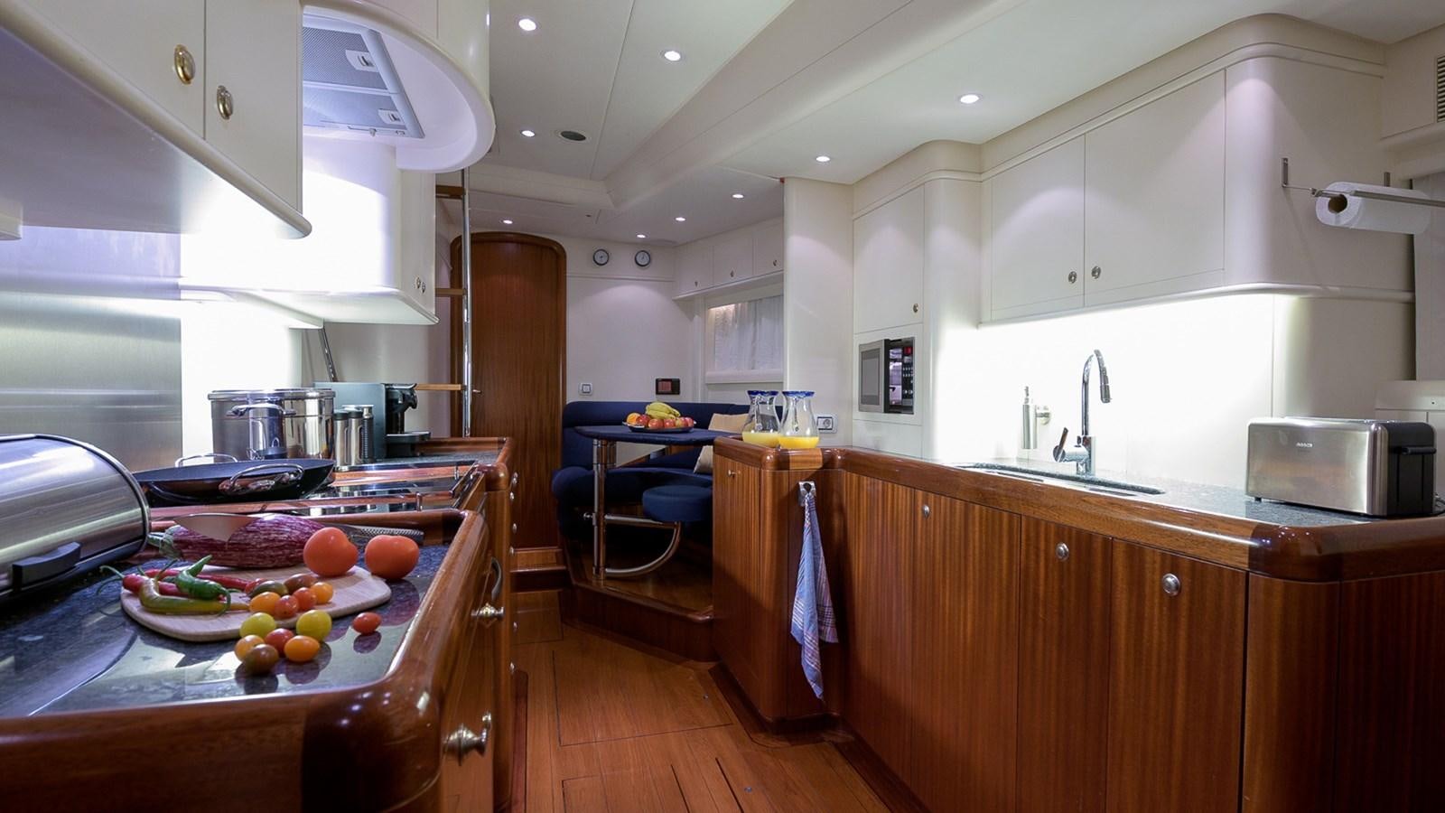 a kitchen with a table and a sink aboard GOOD TIMES Yacht for Sale