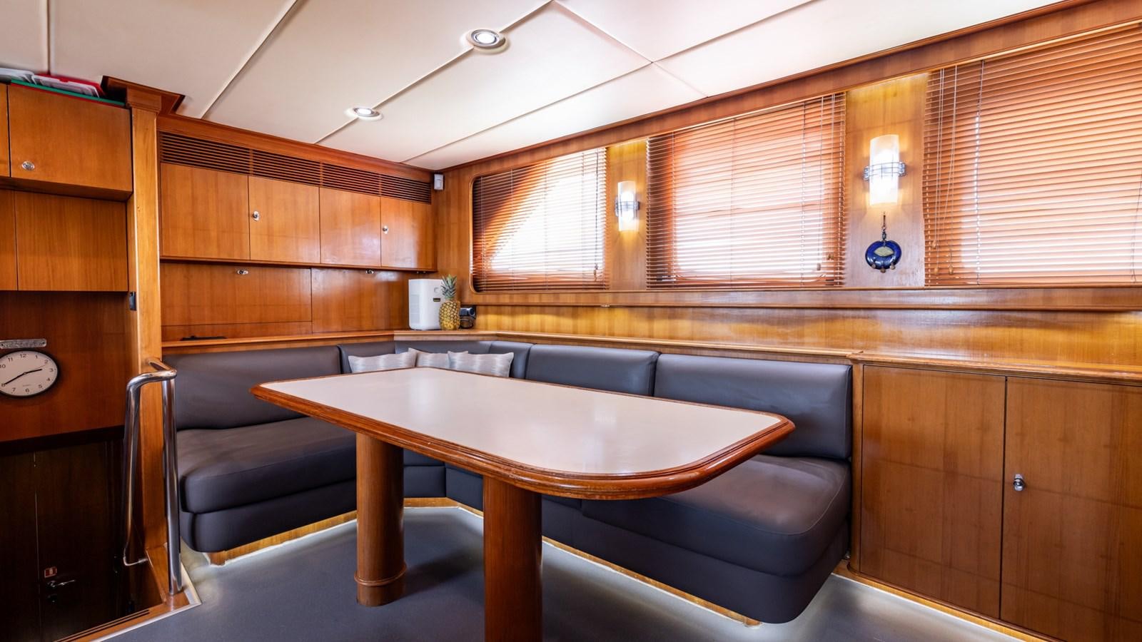 a kitchen with a table and chairs aboard SUNCOCO Yacht for Sale