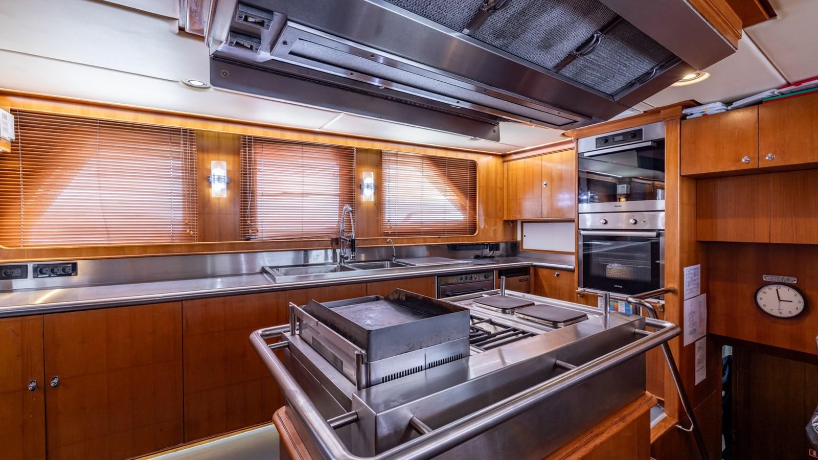 a kitchen with wooden cabinets aboard SUNCOCO Yacht for Sale