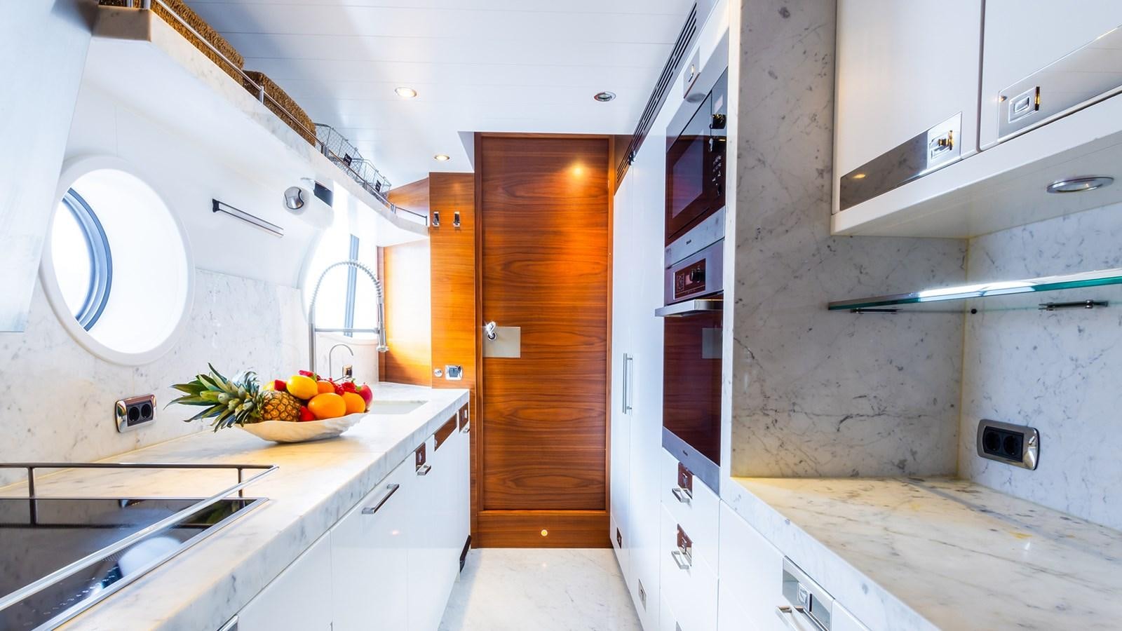 a kitchen with white cabinets aboard HEERLIJCKHEID Yacht for Sale