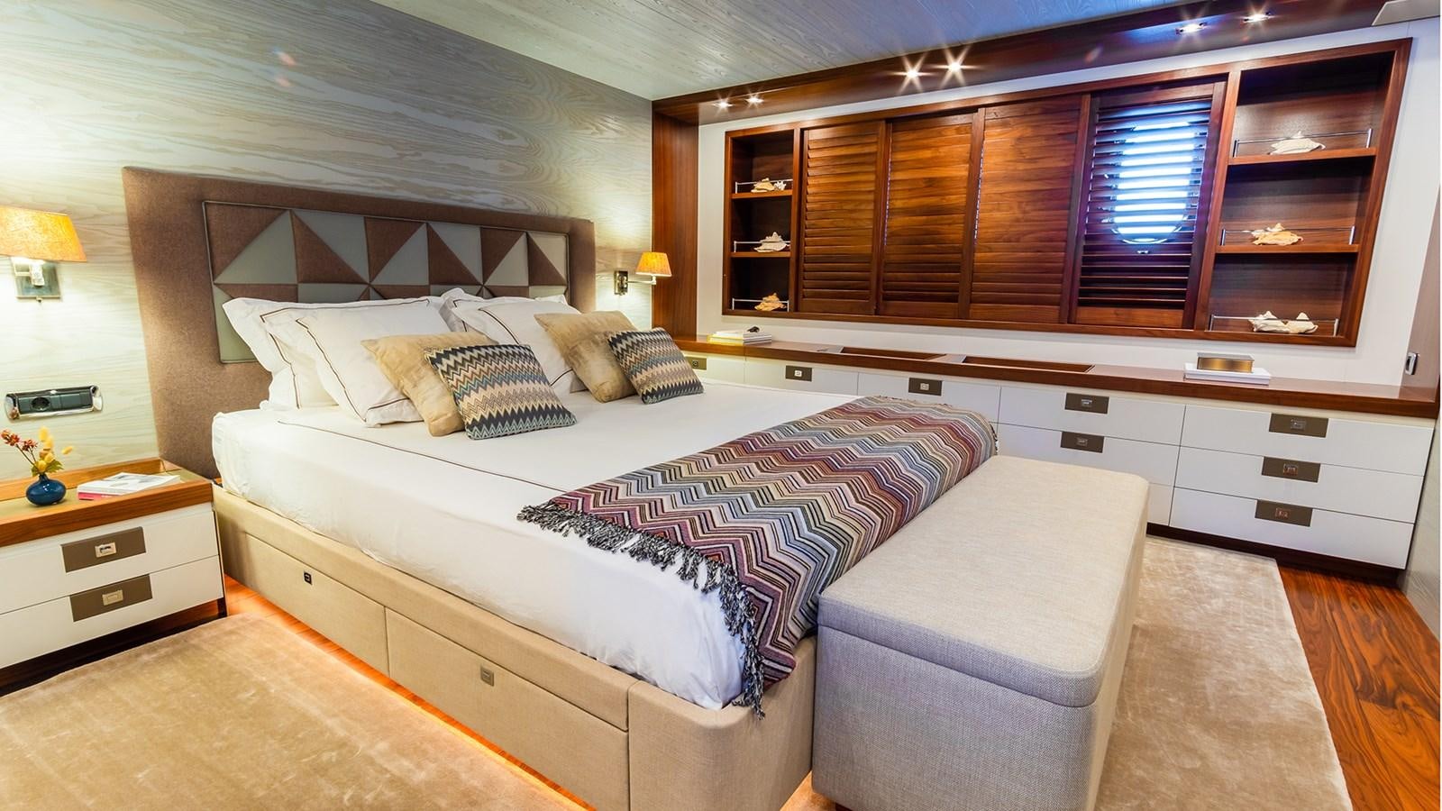 a bedroom with a bed and a chair aboard HEERLIJCKHEID Yacht for Sale