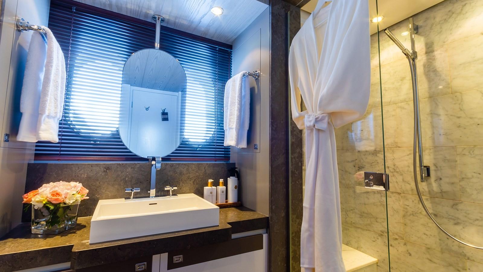a bathroom with a large mirror aboard HEERLIJCKHEID Yacht for Sale