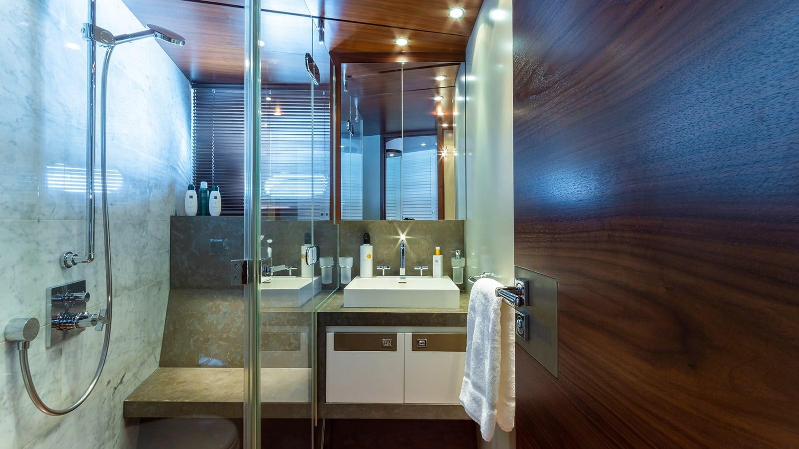 a bathroom with a shower and sink aboard HEERLIJCKHEID Yacht for Sale