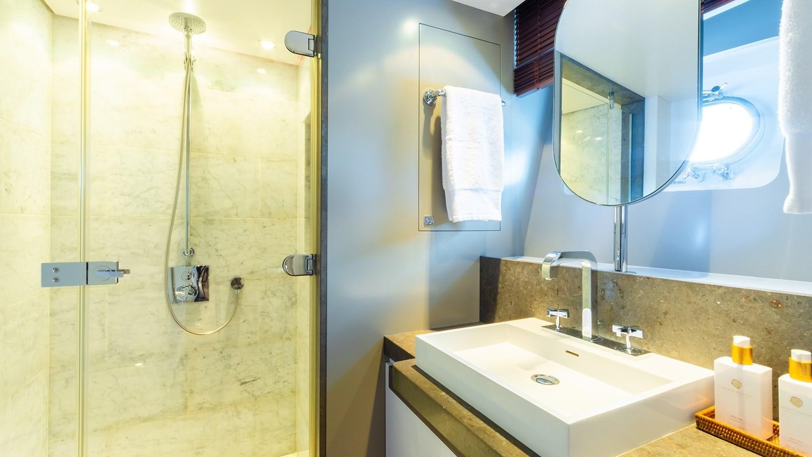 a bathroom with a shower and sink aboard HEERLIJCKHEID Yacht for Sale