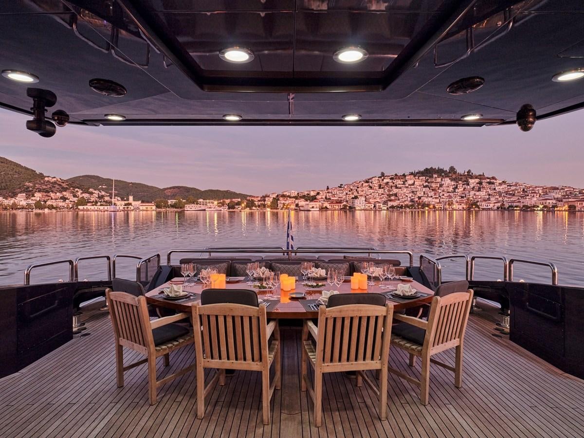 a table and chairs on a deck aboard O'PATI Yacht for Sale