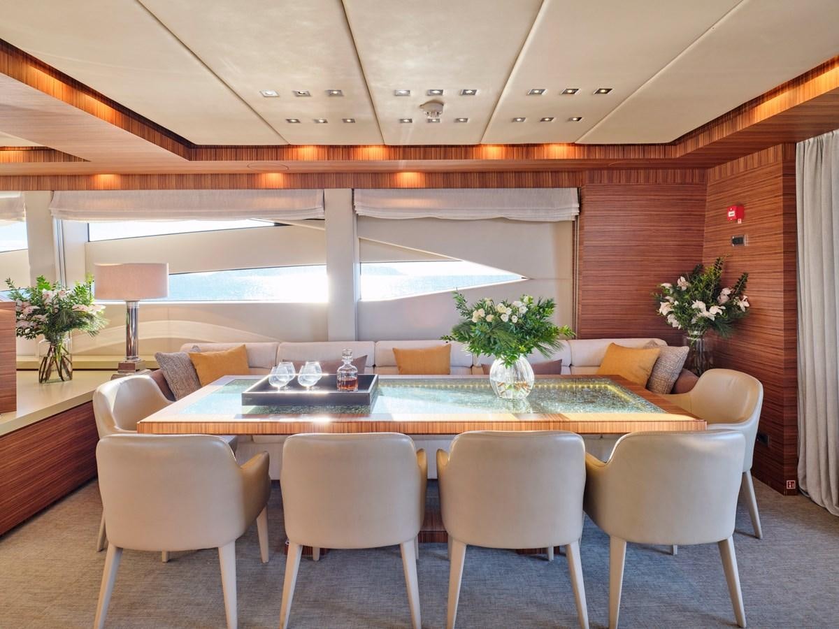 a large room with a table and chairs aboard O'PATI Yacht for Sale