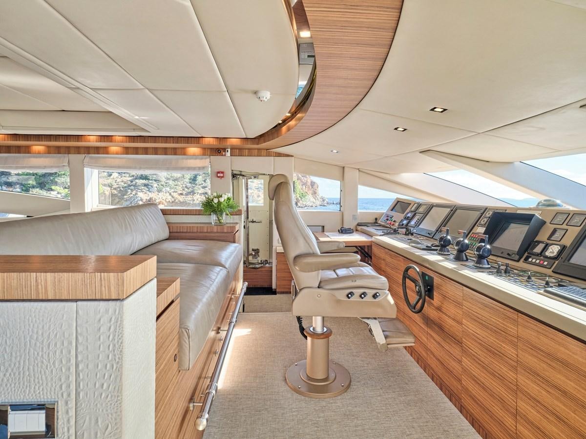 a room with a couch and a table with chairs aboard O'PATI Yacht for Sale