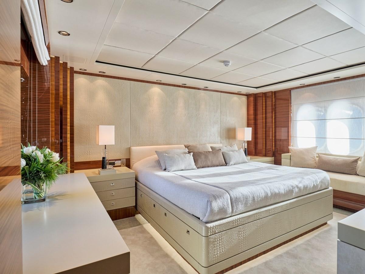 a bedroom with a bed and a desk aboard O'PATI Yacht for Sale